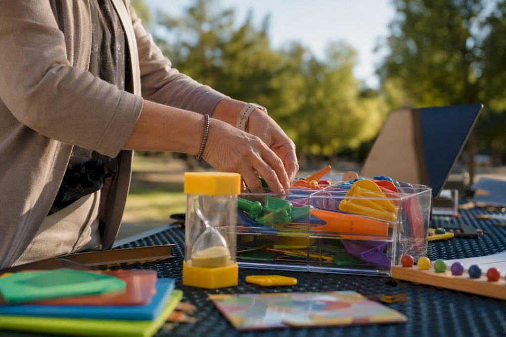 Teacher hands arranging diverse learning tools